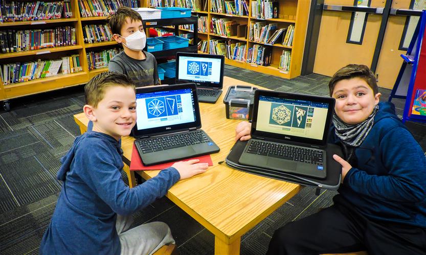 Students on laptops in the library